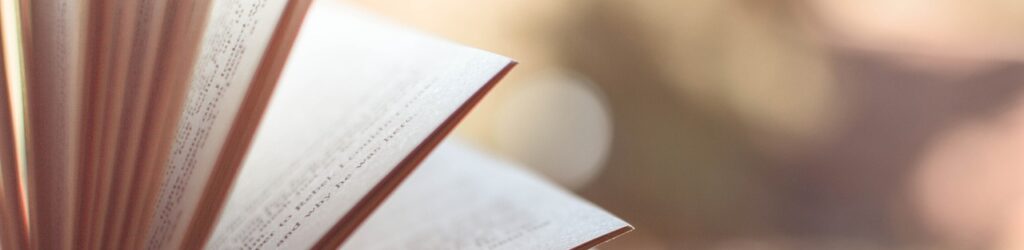 Alt text: A close-up view of the pages of an open book, with a soft background blurred out, evoking a sense of calm and focus, symbolizing the importance of knowledge and wellness in Friday Health.